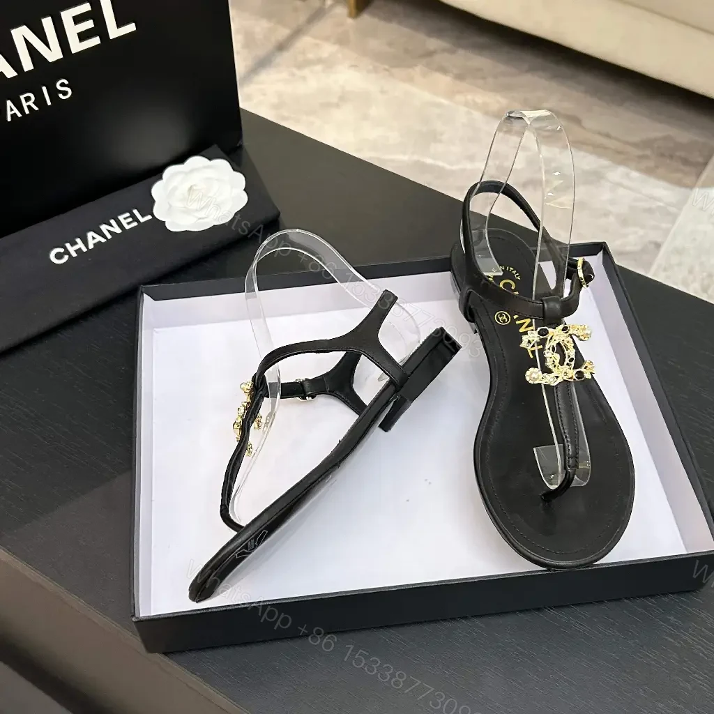 View 4 of Minimalist Black Leather Sandals with Gold Charms - Elegant Comfort