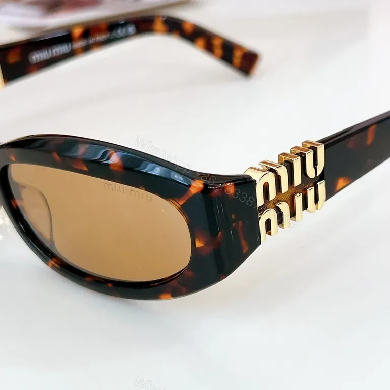 View 4 of Chic Black Miu Miu Sunglasses with Gold Accent - All-Day Shield