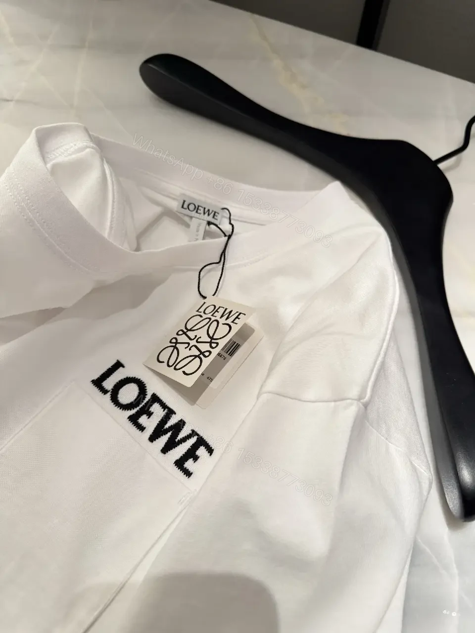 View 9 of Minimalist White Tee with Structured Pocket & Logo Emblem