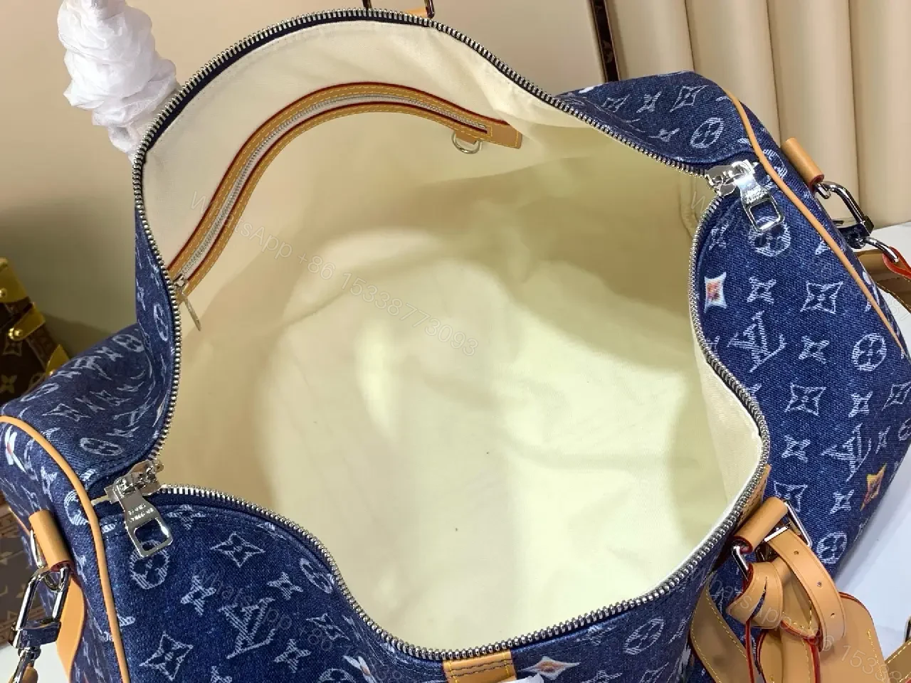 View 10 of Blue denim monogram-print travel bag with tan leather trim for luxury weekends