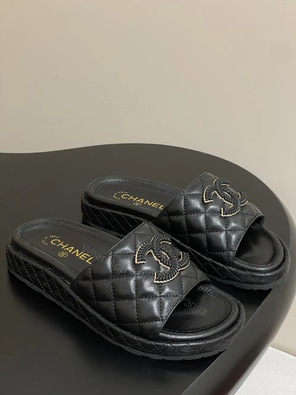 Quilted Black Slip-Ons with Gold Emblem – Luxe Style — view 1