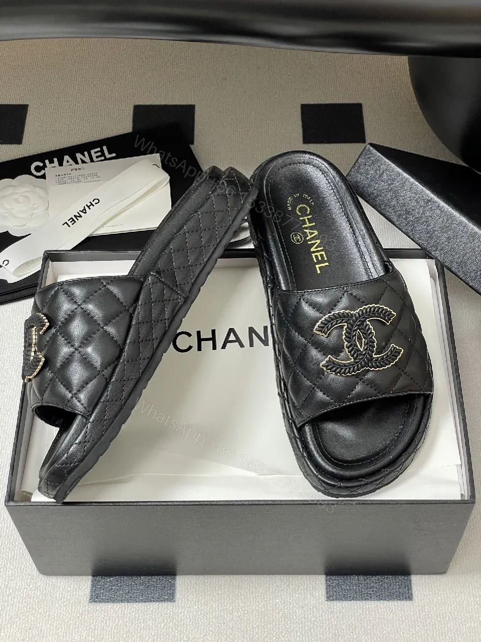View 8 of Quilted Black Slip-Ons with Gold Emblem – Luxe Style