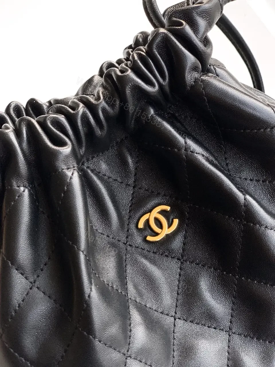View 5 of Quilted Drawstring Bag - Black Leather-Feel, Gold Accent