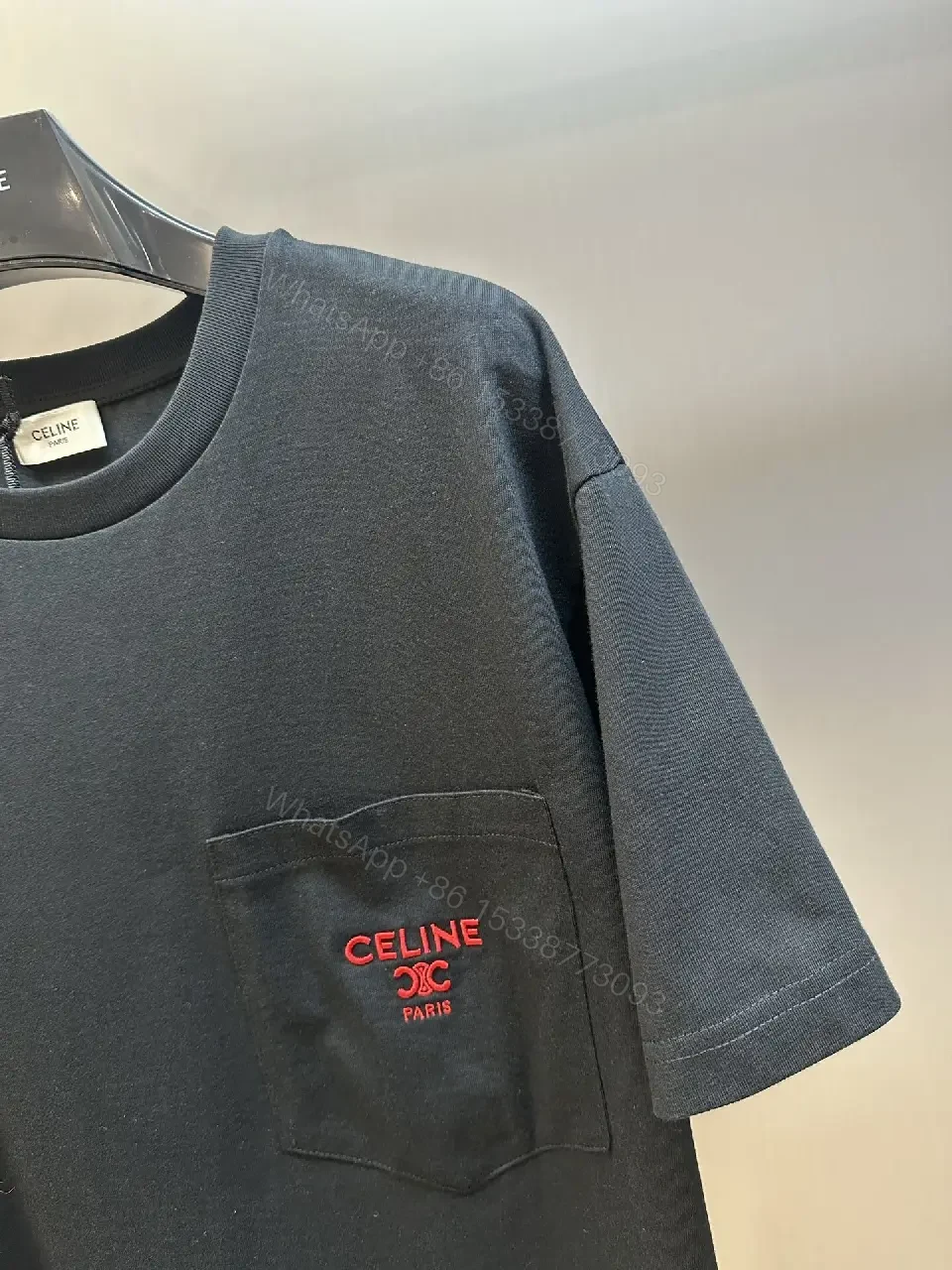 View 6 of Minimalist Black Tee with Red Pocket Detailing - Premium Unisex Tee