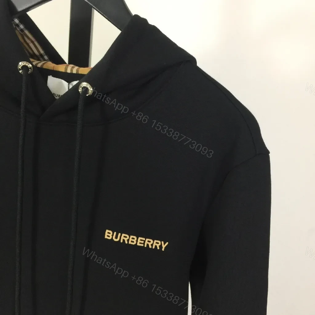 View 5 of Minimalist Black Hoodie with Gold Logo – Premium Casual Wear