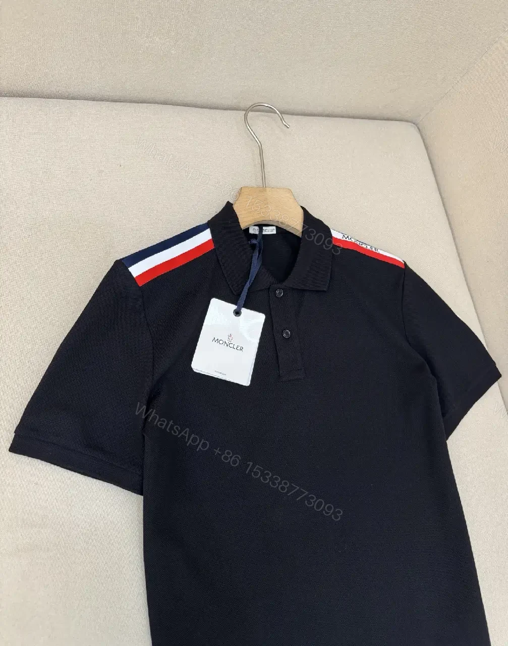 View 3 of Navy cotton polo shirt with red-white striped shoulder accents for everyday luxury