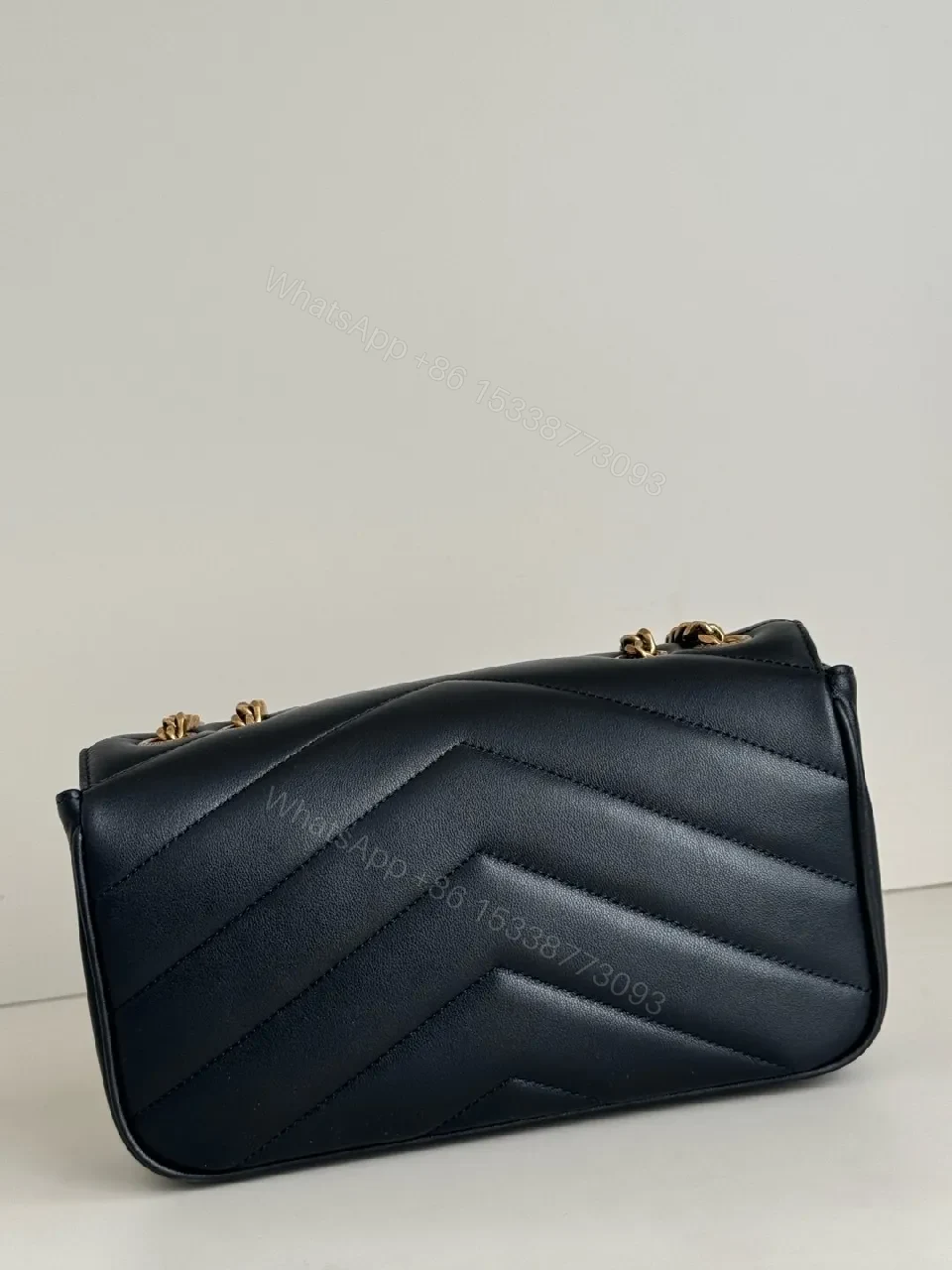 View 7 of Quilted Leather Crossbody Bag with Gold Emblem, Luxury Style