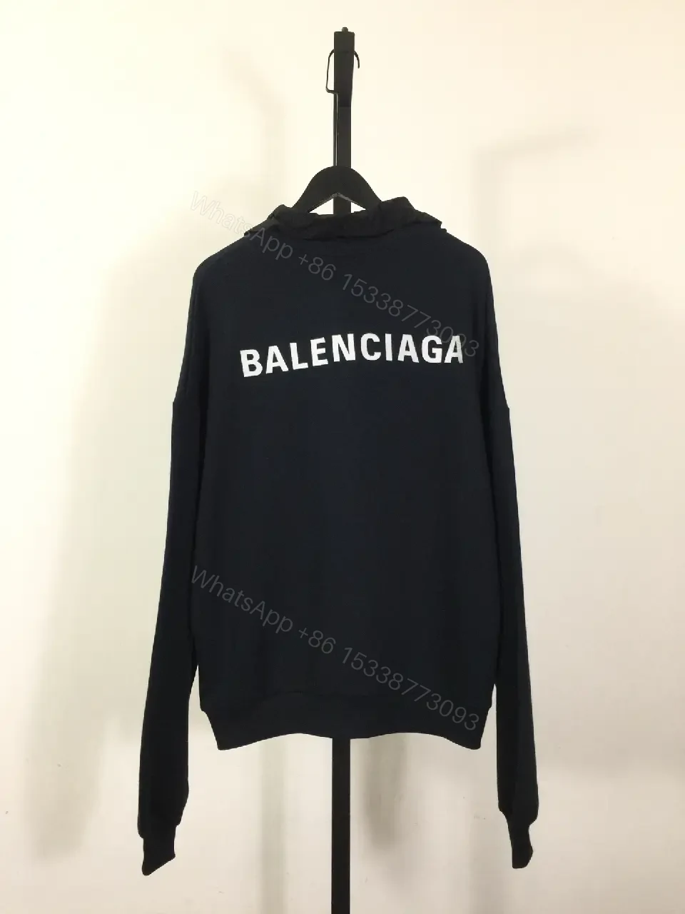 View 9 of Deep Black Hoodie: Minimalist Logo, Premium Knitwear, Relaxed Fit