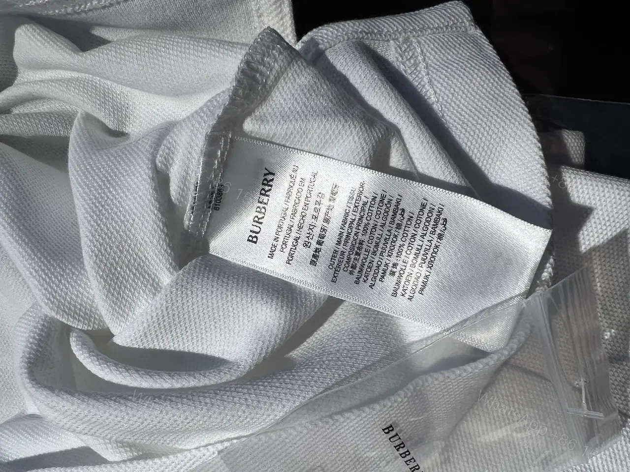 View 8 of White Piqué Polo with Signature Check Collar - Contemporary Luxury