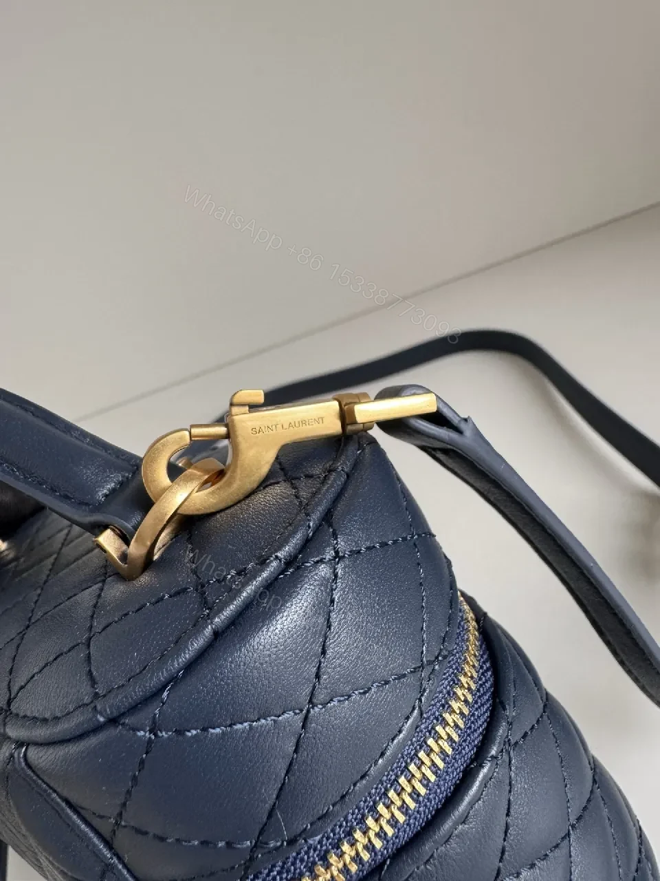 View 2 of Navy Quilted Leather Crossbody Bag with Gold Hardware