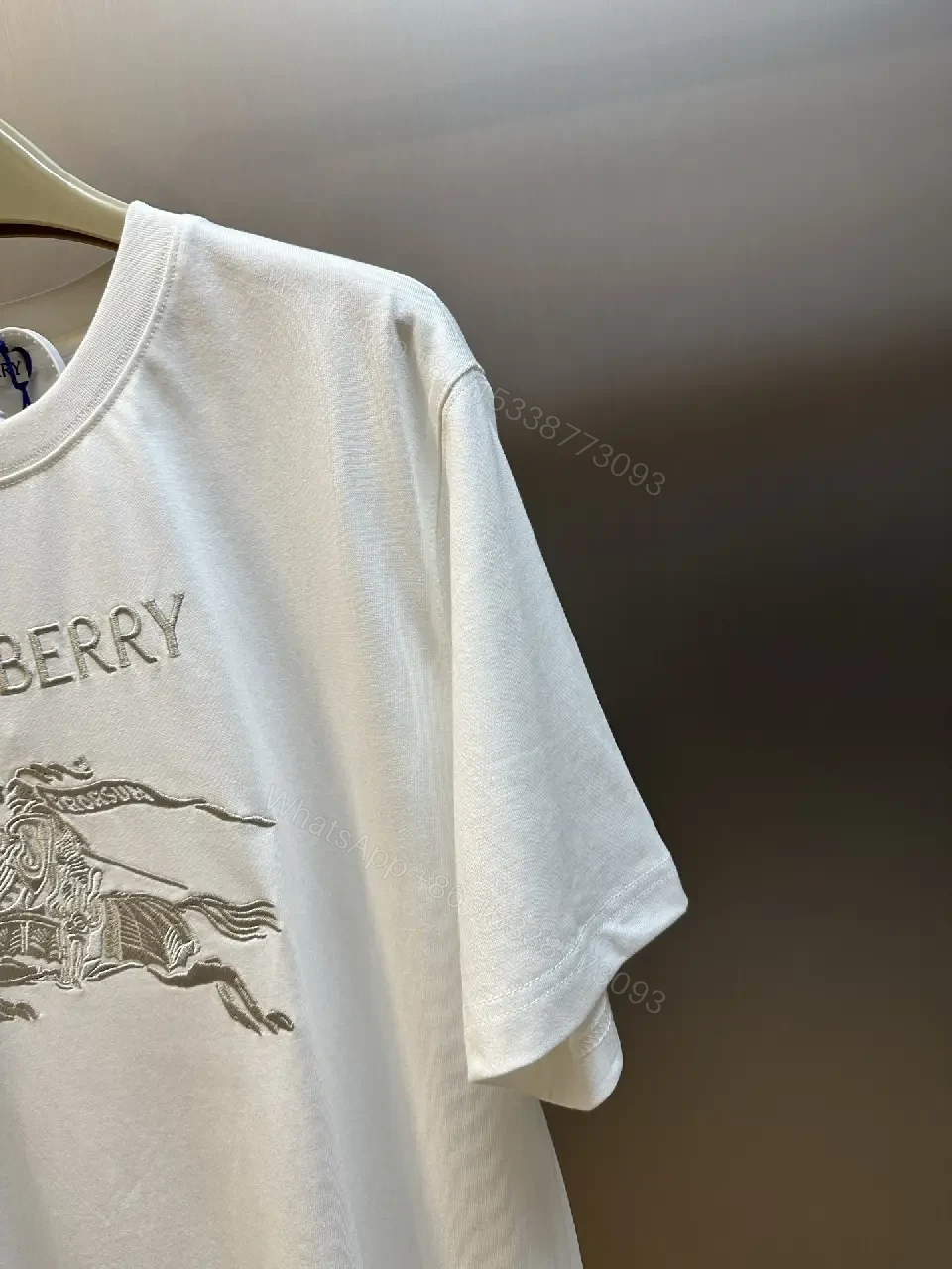 View 11 of Minimalist White Tee with Iconic Horse Motif, Premium Cotton