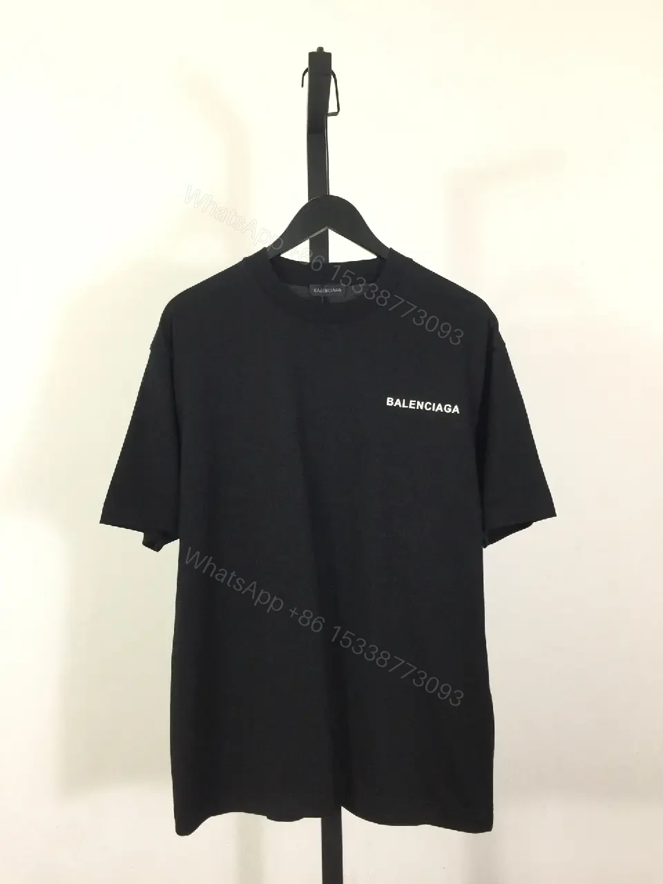 View 6 of Minimalist Black Mockneck Tee: Premium Cotton, Subtle Logo, Versatile Style