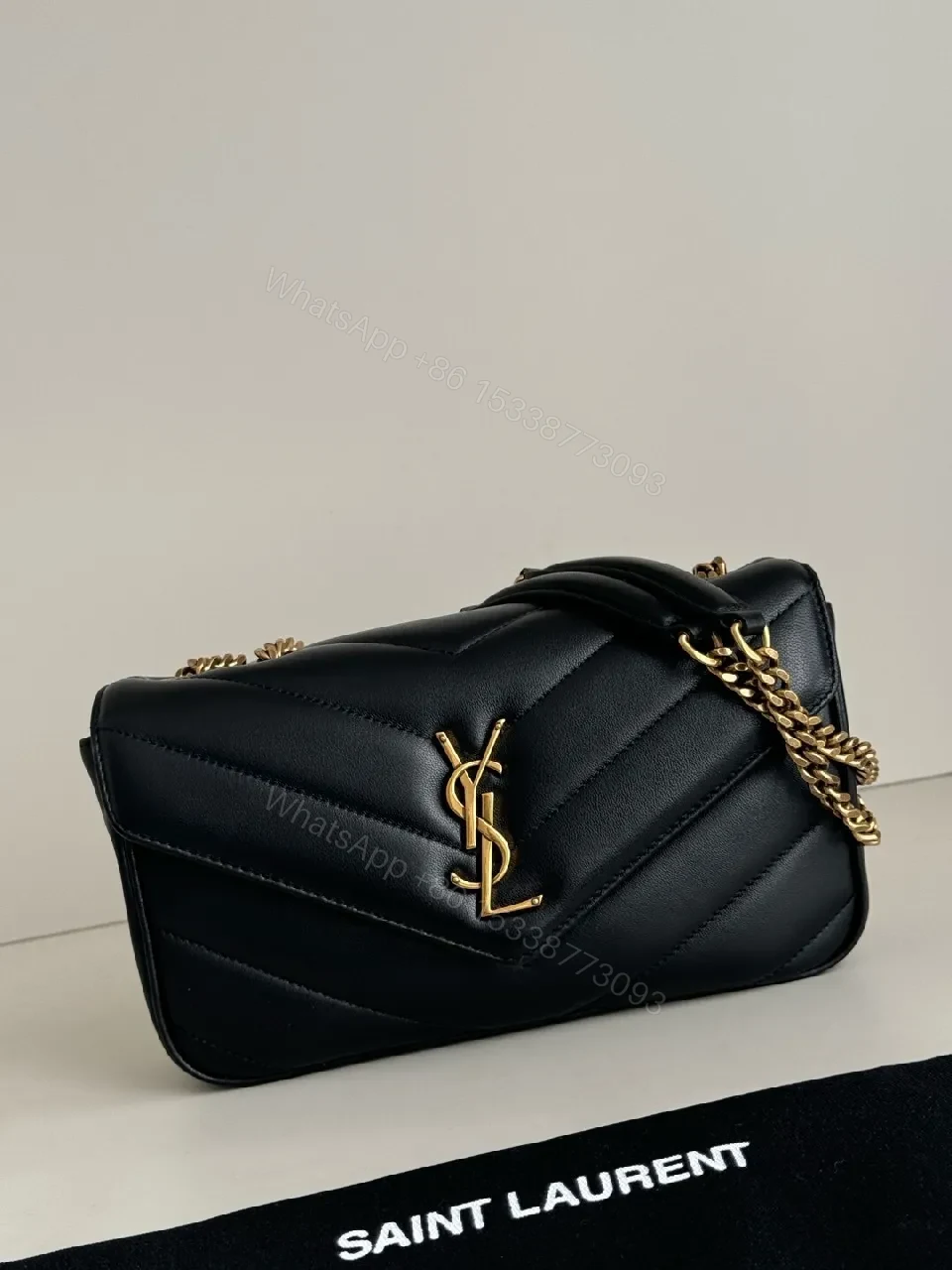 Quilted Leather Crossbody Bag with Gold Emblem, Luxury Style — view 1