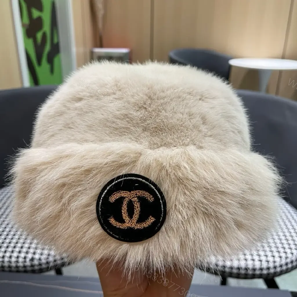 View 11 of Cream Faux Fur Pom Hat: Lux Soft Warmth, Subtle Logo Accent