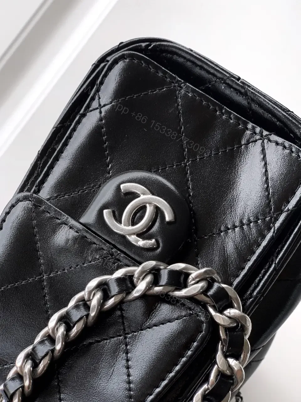 View 4 of Quilted Black Leather Bag with Chain Strap—Compact Elegance