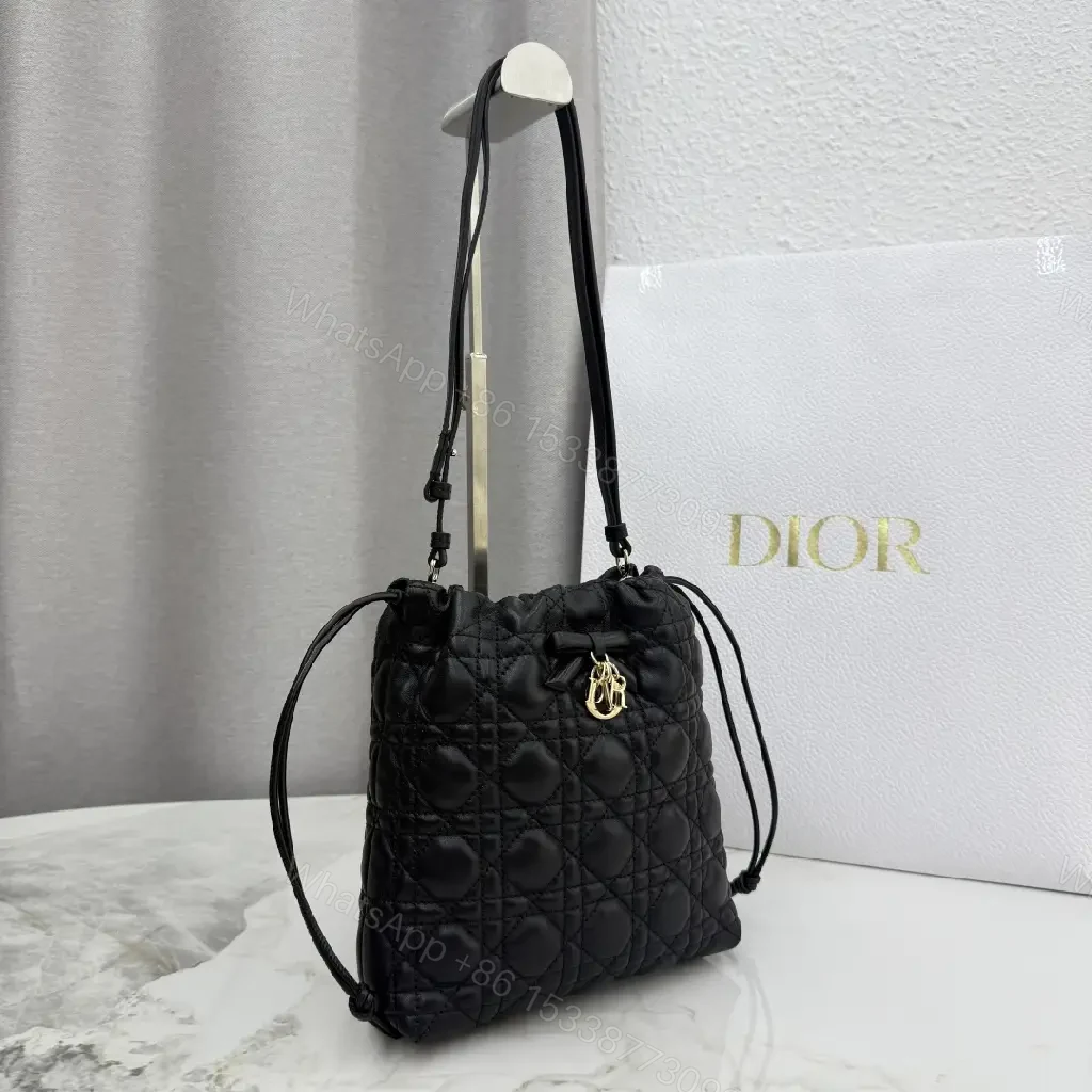 View 4 of Quilted Black Drawstring Bucket Bag with Gold Hardware