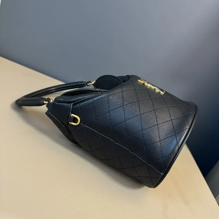 View 8 of Structured Black Quilted Bucket Bag with Gold Accents