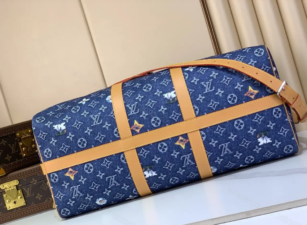 View 2 of Blue denim monogram-print travel bag with tan leather trim for luxury weekends
