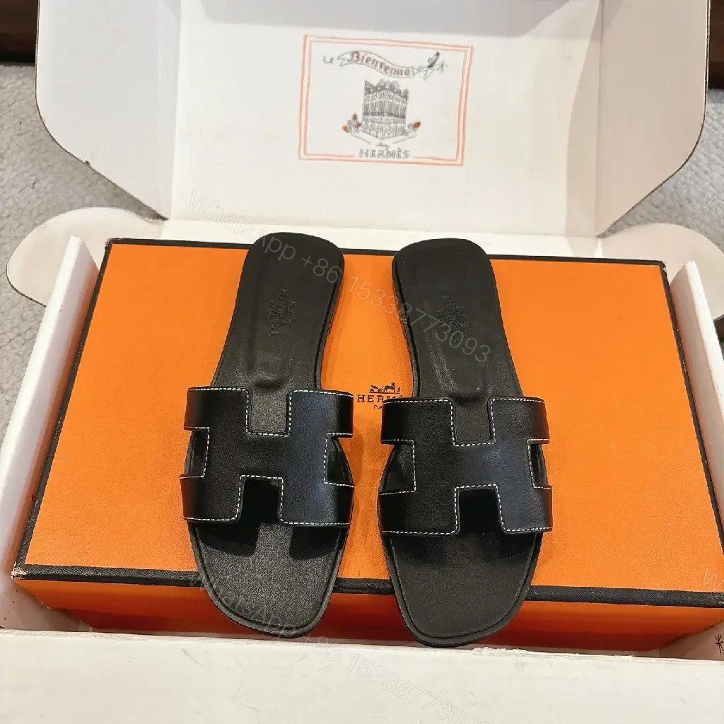 View 2 of black leather slide sandals with H-shaped buckles for luxury everyday