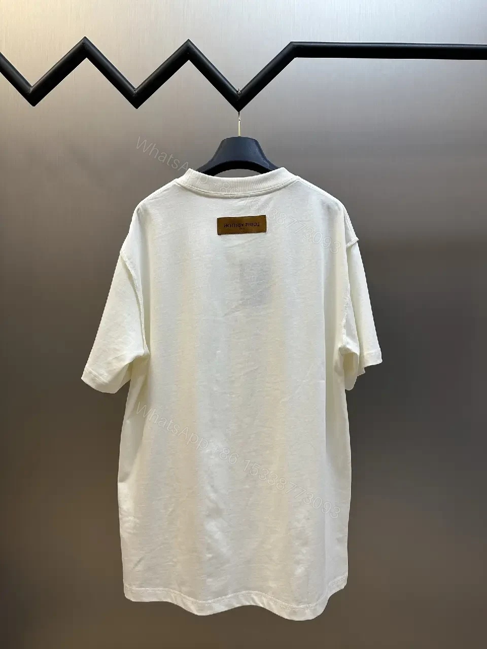 View 2 of Oversized White Tee with Subtle Embossed Logo - Minimal Luxury
