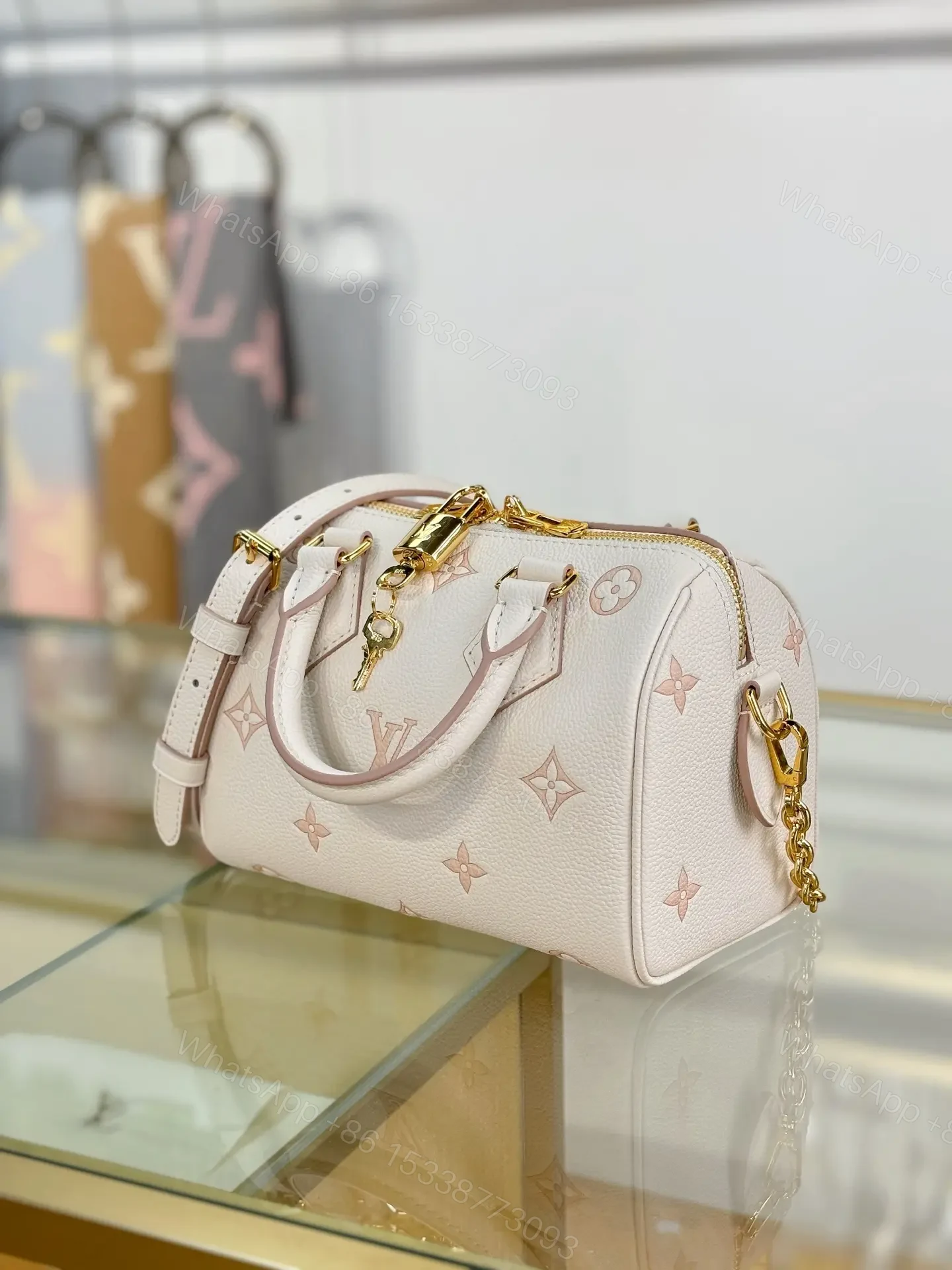 View 7 of Louis Vuitton Monogram Empreinte Bicolor Speedy Bandoulière 20