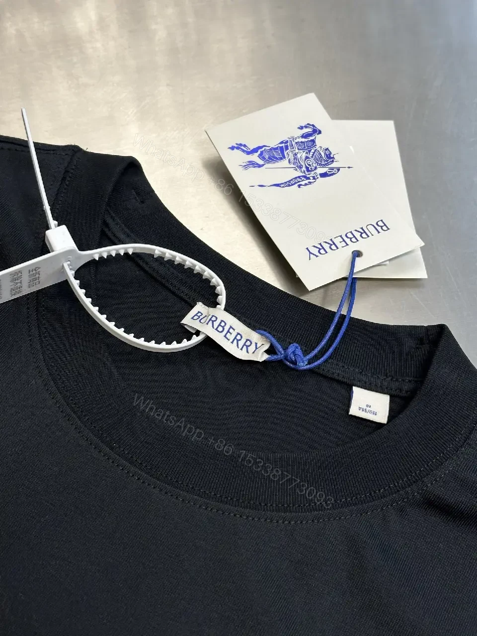 View 5 of Minimalist Black Cotton Tee | Relaxed Fit, Logo Accent, Everyday Luxury