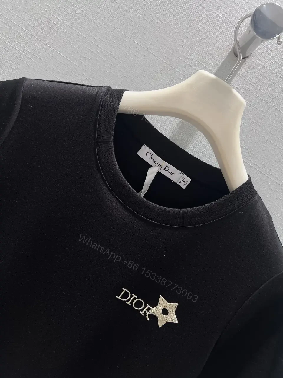 View 10 of Minimalist Black Cotton Tee with Discreet Emblem