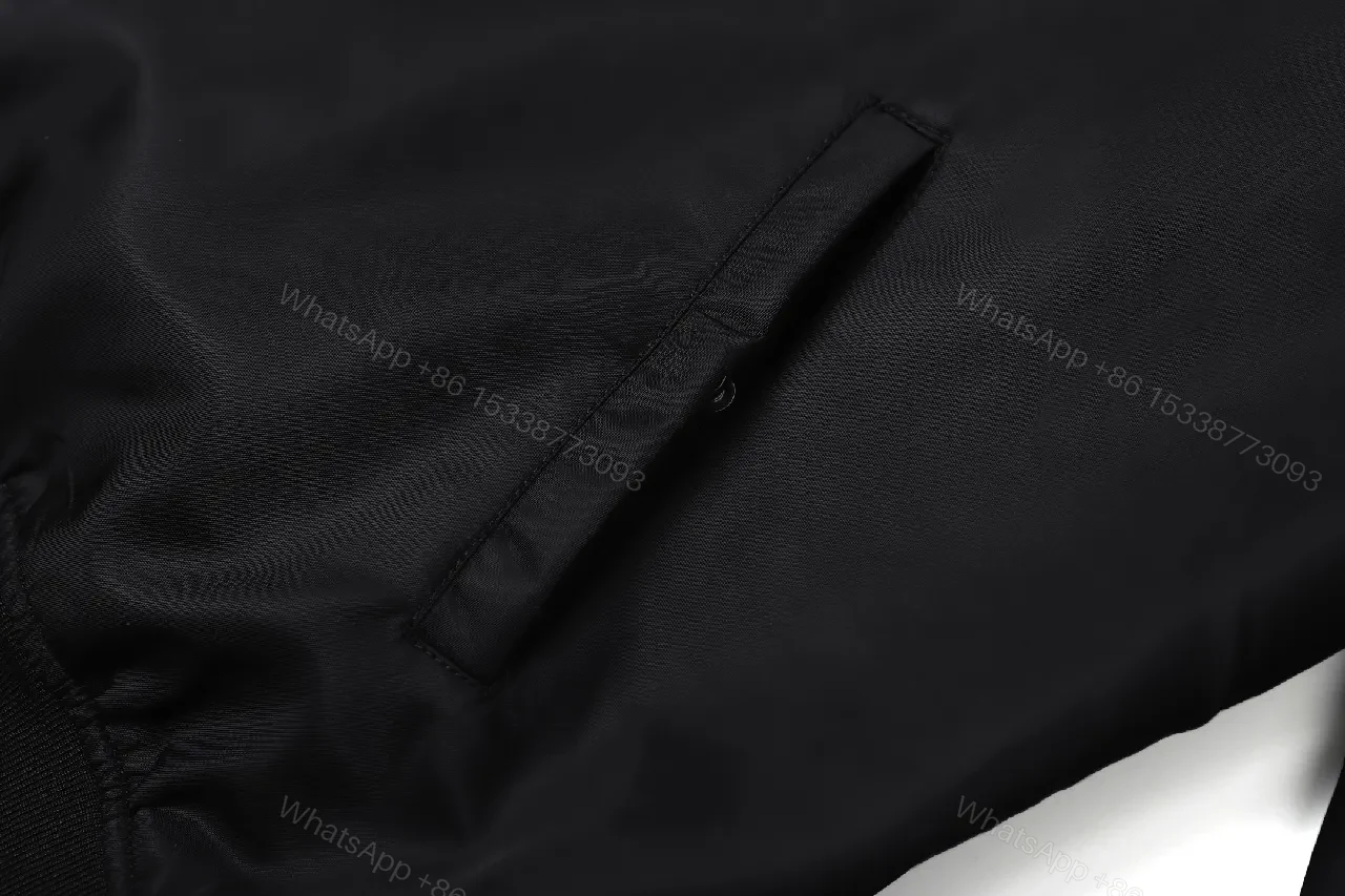 View 3 of Minimalist Black Bomber with Gold Accent: Modern Luxury Outerwear