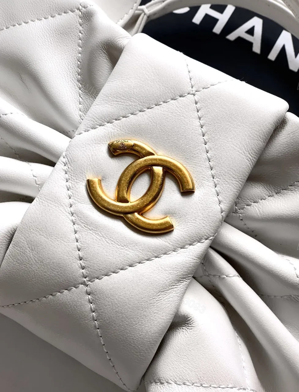 View 4 of Pearl White Quilted Satin Mini Bag with Bow Detail and Gold Logo