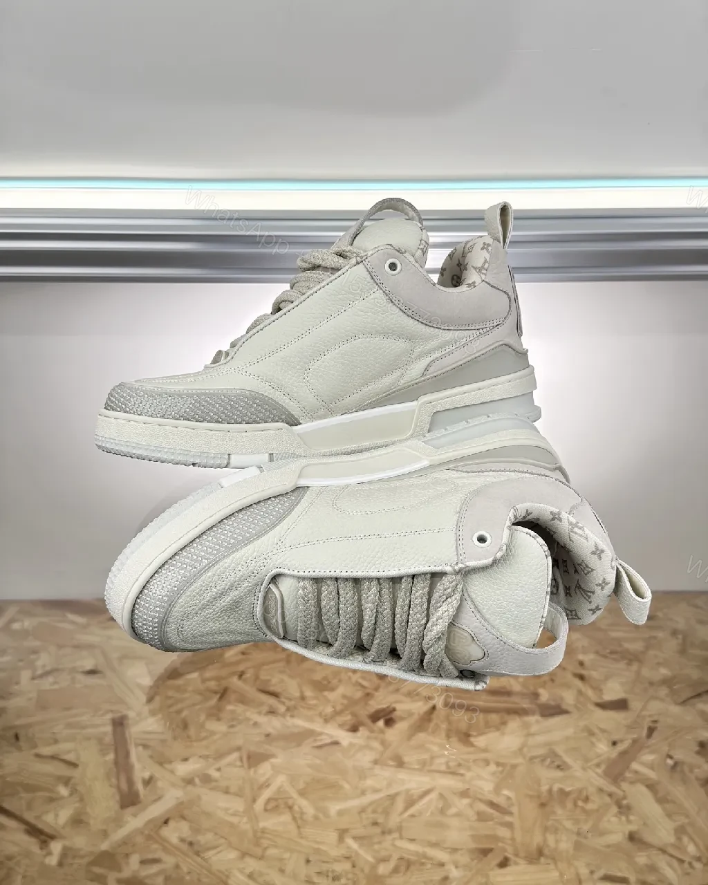 View 8 of Textured White Leather Sneakers with Signature Motif, Modern Luxury
