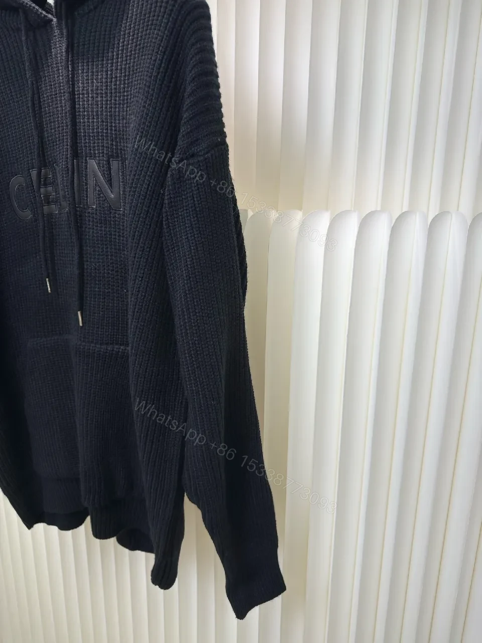 View 9 of Chunky Knit Hoodie in Deep Black with Subtle Logo Embossing, Modern Luxe