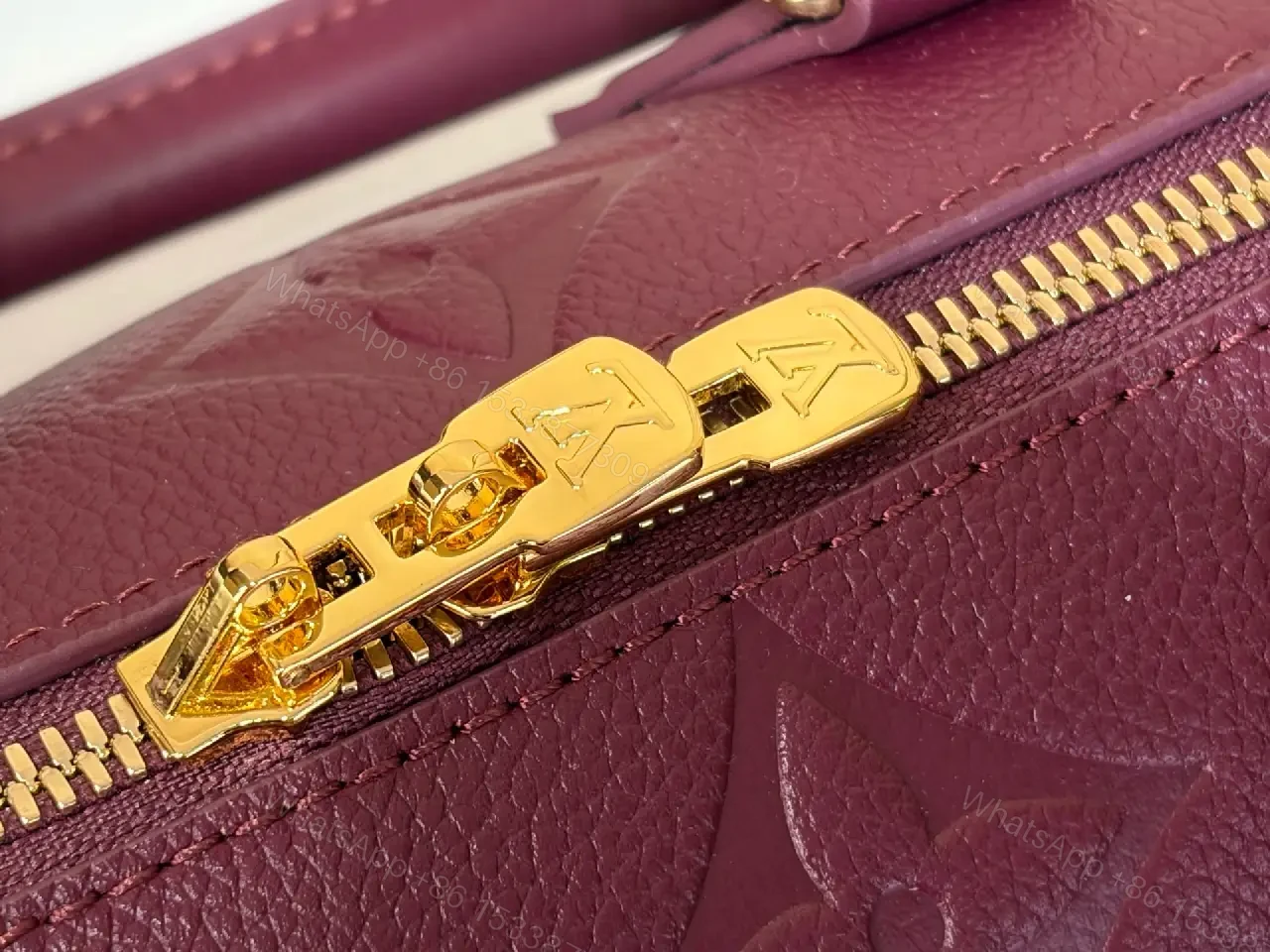 View 9 of Deep Plum Leather Satchel: Structured Top-Handle Bag with Embossed LV Motifs