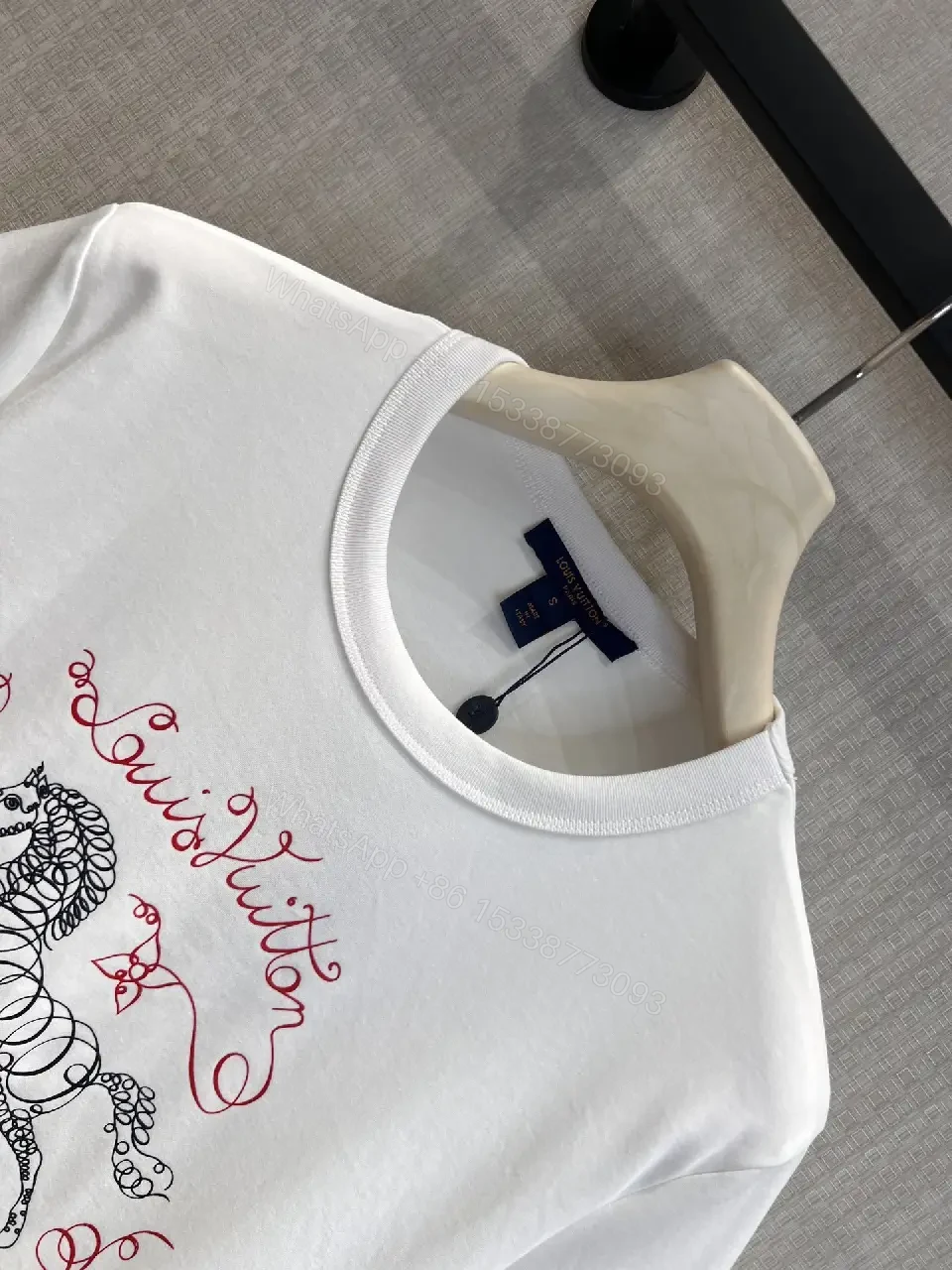 View 5 of White Cotton Luxe Tee with Signature Crest Graphic - Casual Premium Style