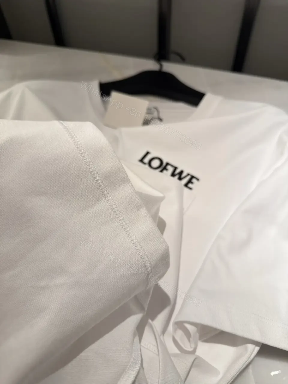 View 2 of Minimalist White Tee with Structured Pocket & Logo Emblem