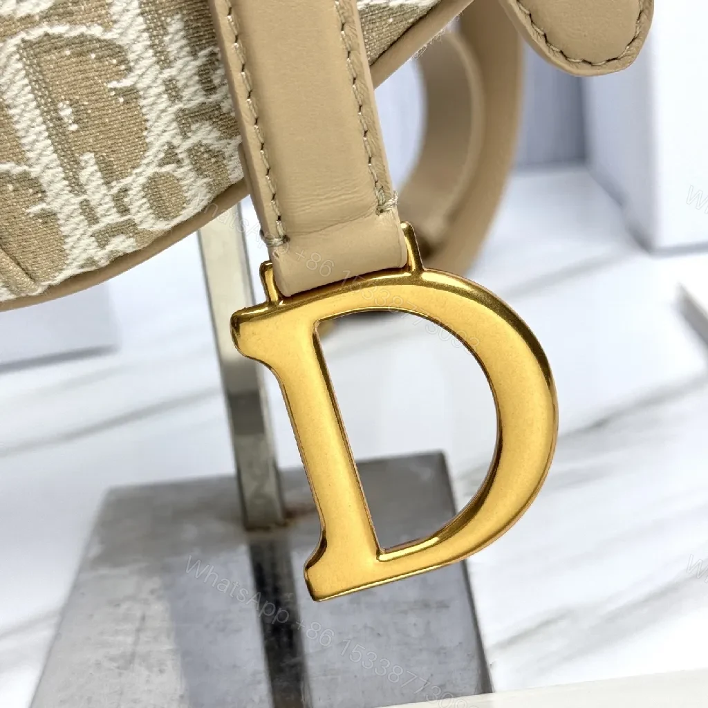 View 2 of Beige Leather-Trim Mini Saddle Bag, Monogram Canvas, Crossbody