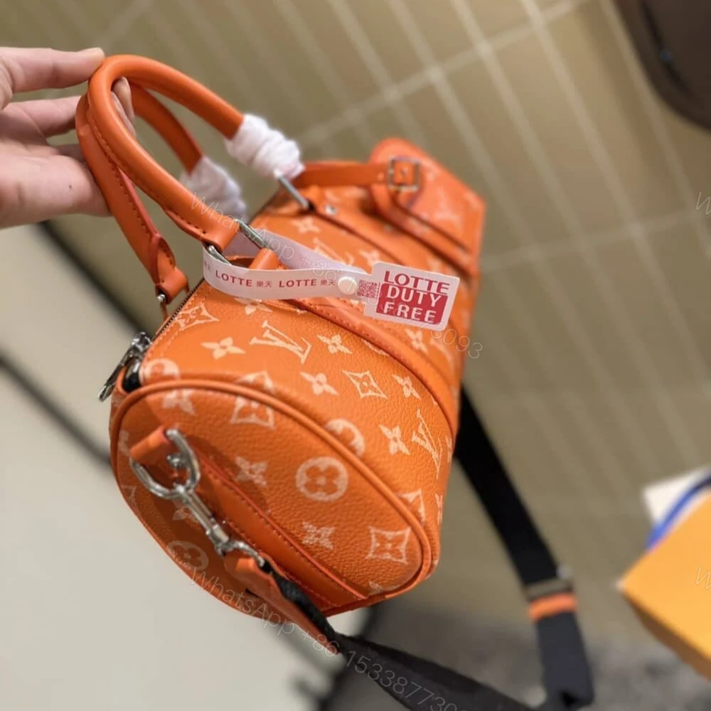 View 2 of Louis Vuitton Keepall Bandoulière 25 Tangerine 25Cm M31044