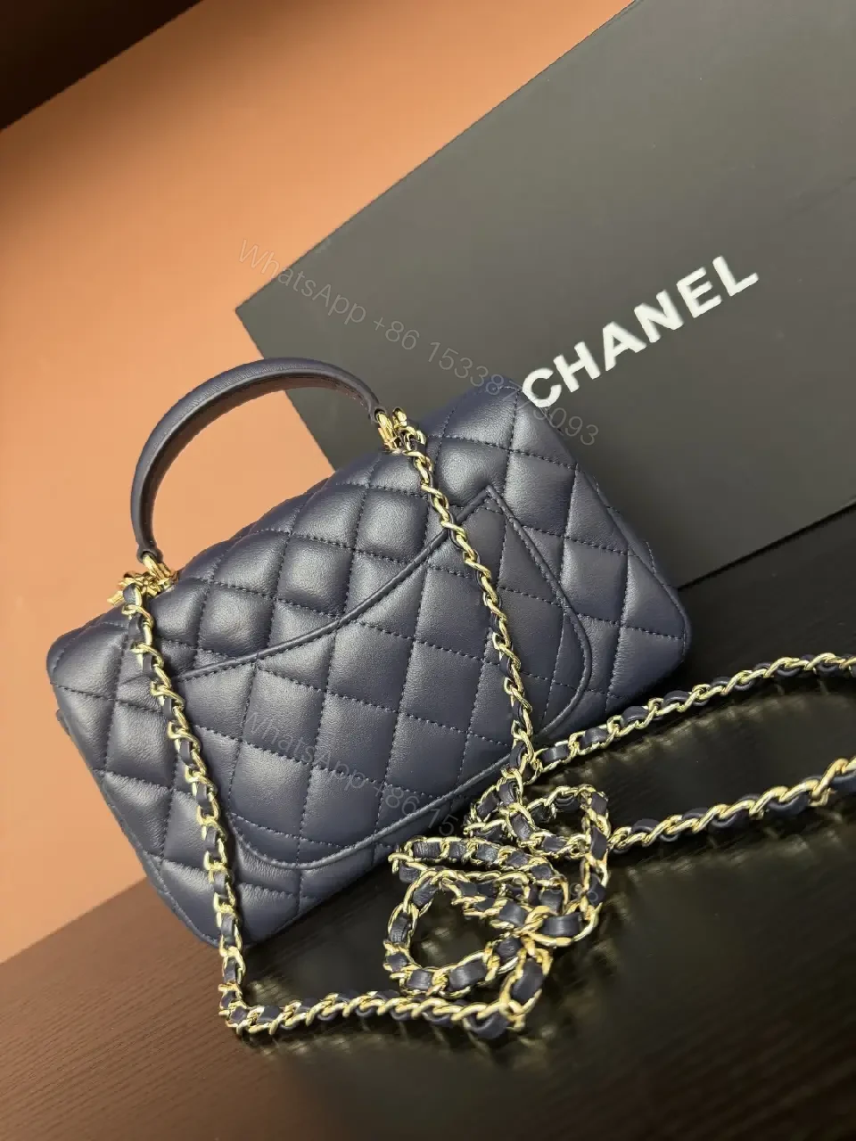 View 5 of Quilted Leather Mini Bag with Gold Emblem - Compact Glamour