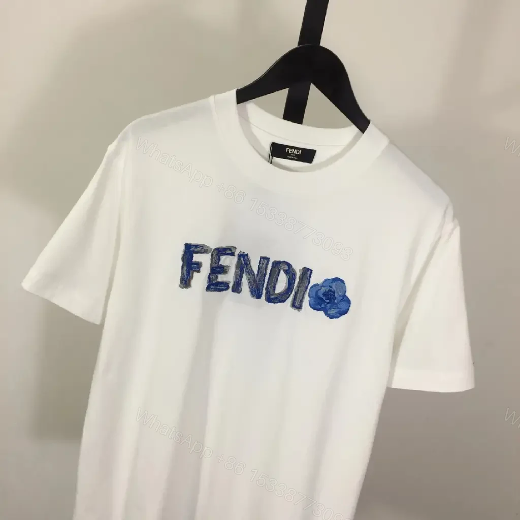 View 9 of White Cotton/Poly blend Short-sleeve Crew Neck Bold FENDI logo with blue flower T-shirt