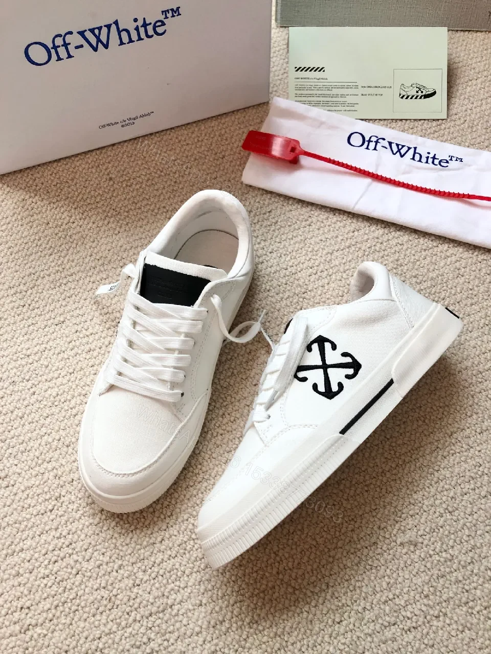 View 7 of Minimalist White Leather Low-Top Sneakers with Signature Detail