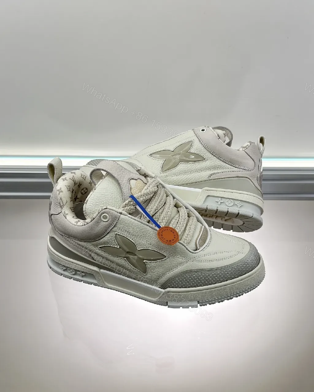 View 5 of Textured White Leather Sneakers with Signature Motif, Modern Luxury