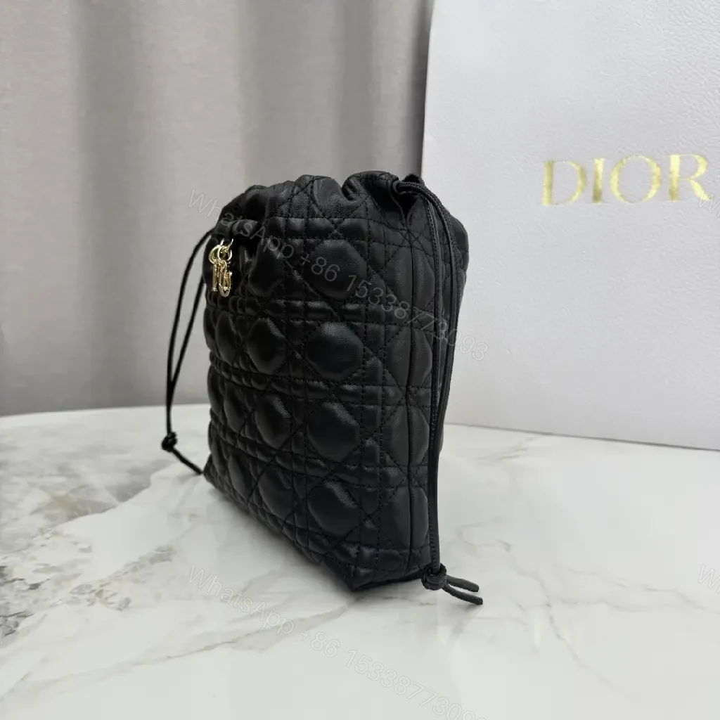 View 2 of Quilted Black Drawstring Bucket Bag with Gold Hardware