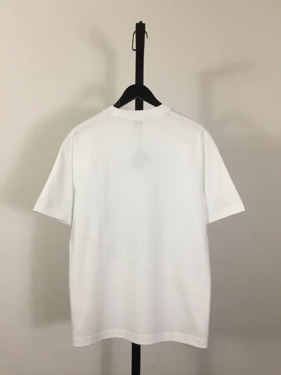 View 7 of White Cotton Graphic Tee – Opulent Comfort, Bold Logo, Casual Luxury