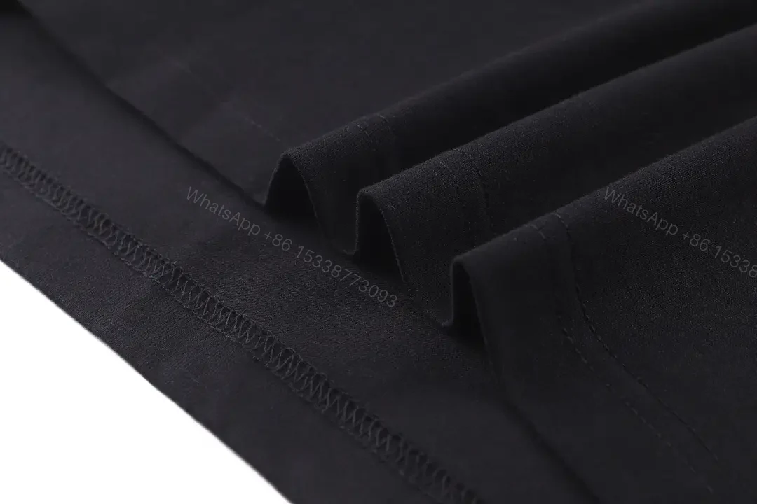 View 10 of Black Cotton Logo Tee: Subtle Crest, Everyday Luxe Top