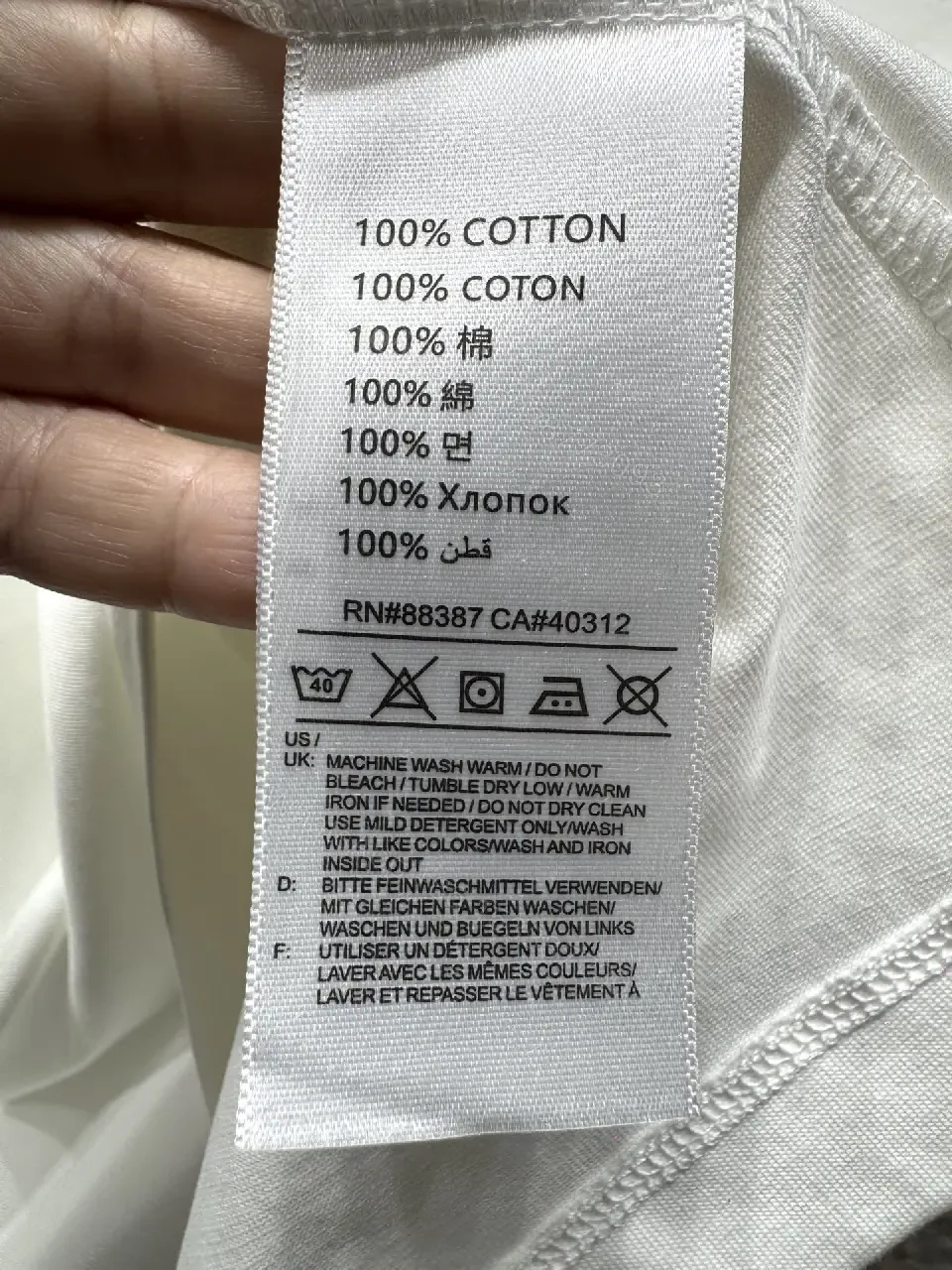 View 3 of Minimalist White T-Shirt with Subtle LV.M Emblem - Premium Cotton