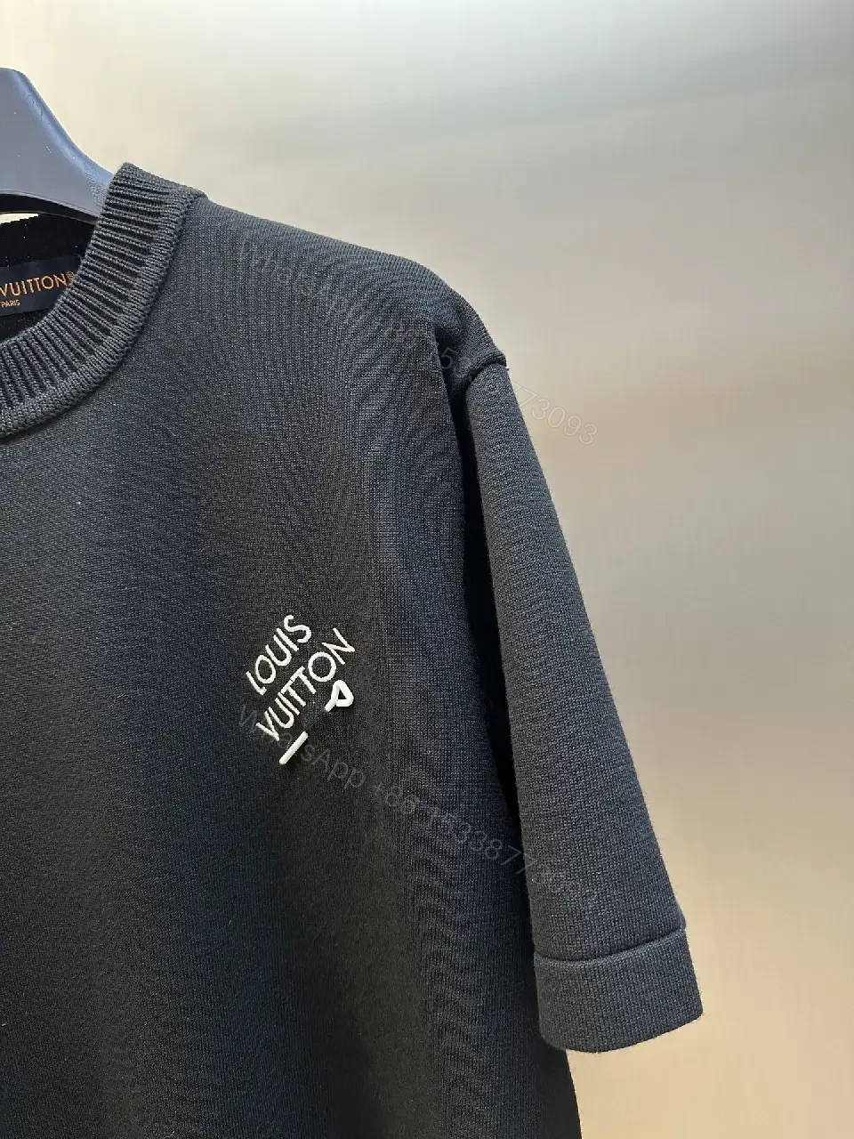 View 4 of Minimalist Black Crewneck Tee Dress – Subtle Logo, Versatile Dress