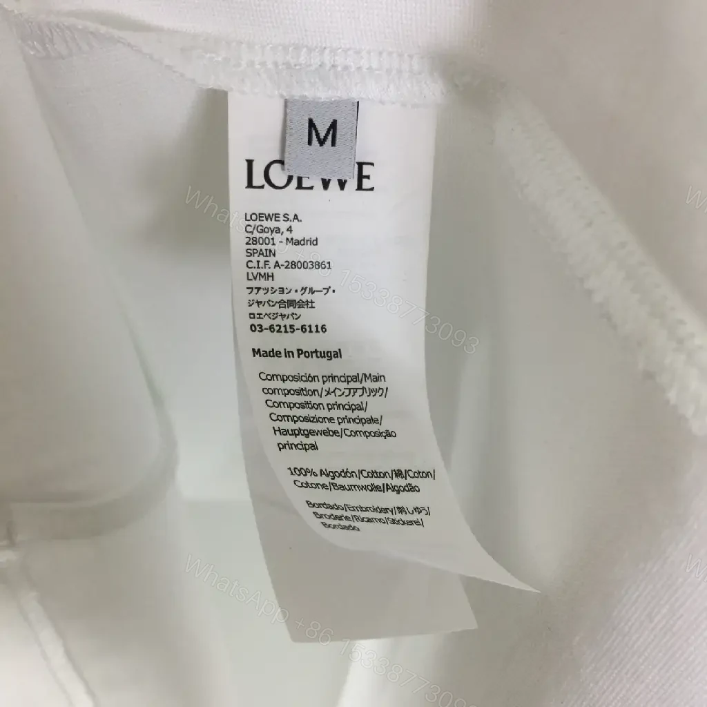 View 6 of White Cotton Graphic Tee – Opulent Comfort, Bold Logo, Casual Luxury