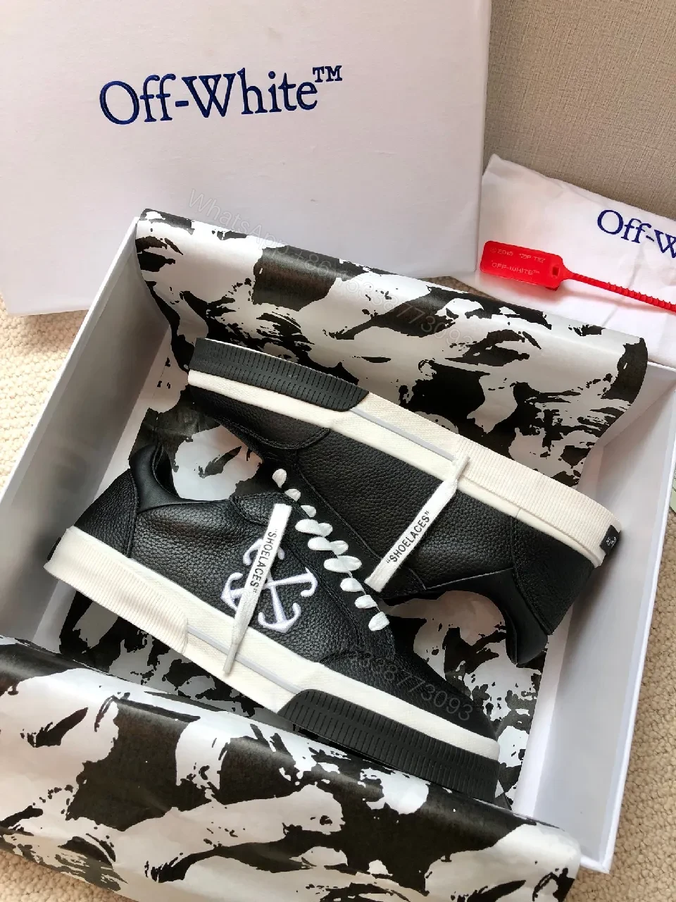 View 4 of Low-Top Black Pebbled Leather Sneakers with Signature Detailing