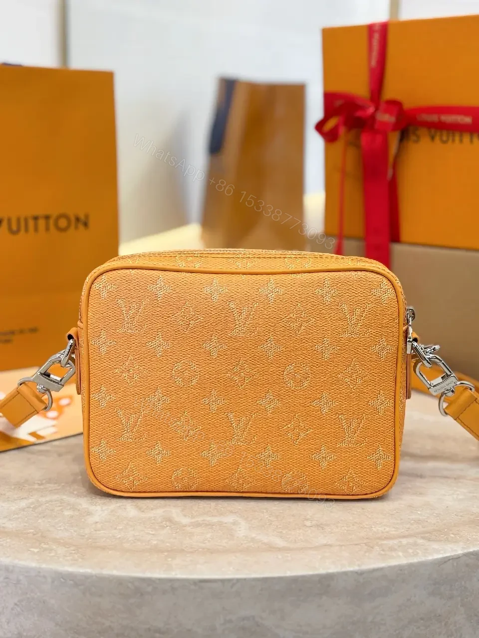 View 2 of Caramel Canvas Crossbody: Textured Monogram, Compact Chic