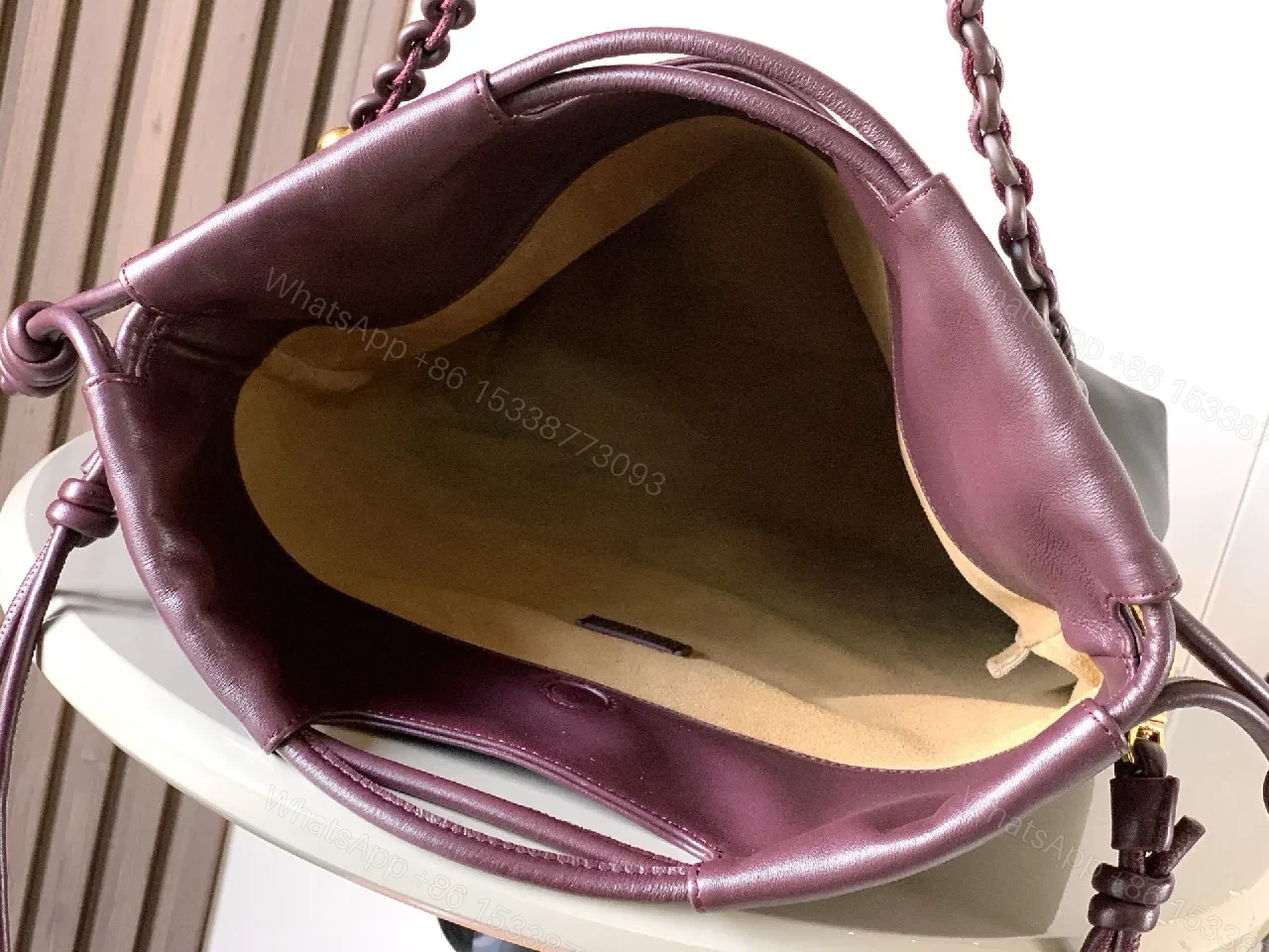 View 4 of Two-Tone Leather Drawstring Bucket Bag with Chain Detail