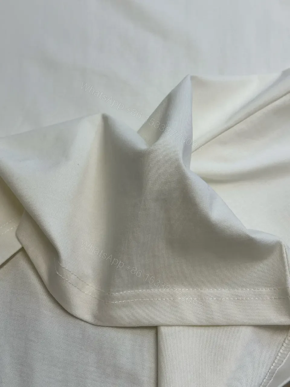 View 11 of Oversized White Tee with Subtle Embossed Logo - Minimal Luxury